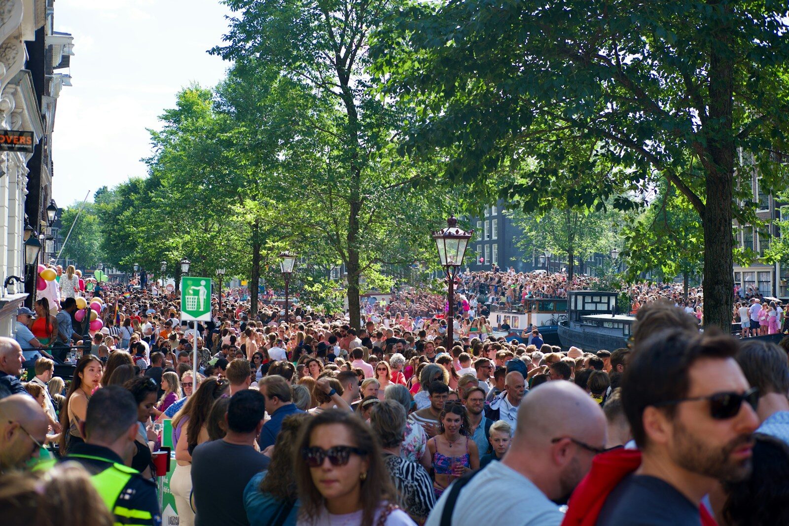 a large crowd of people walking down a street