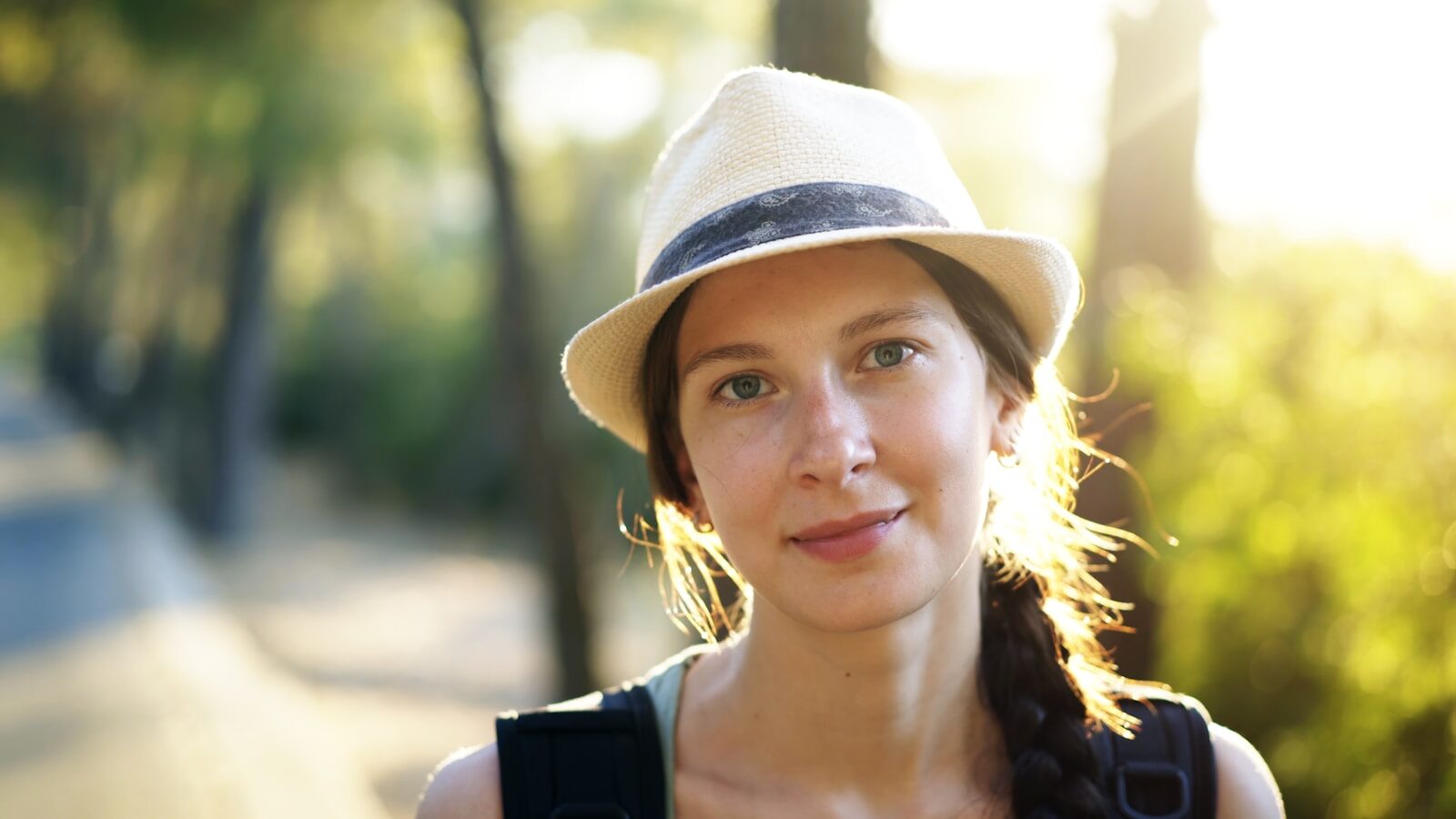 a woman wearing a hat and a black shirt